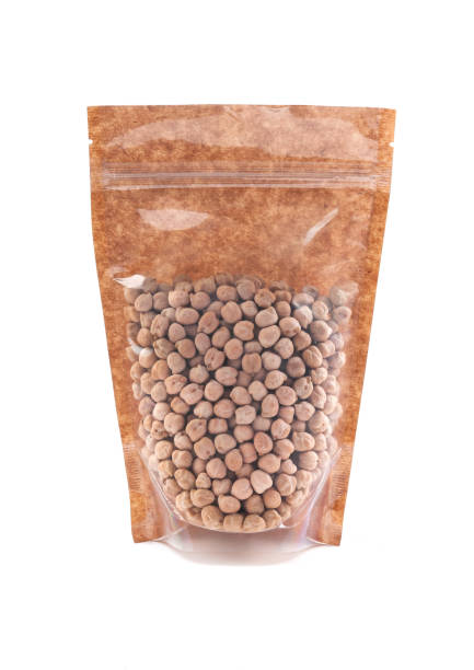 istock Chickpeas in a brown paper bag. Doy-pack with a plastic window for bulk products. Close-up. White background. Isolated. 1310393230