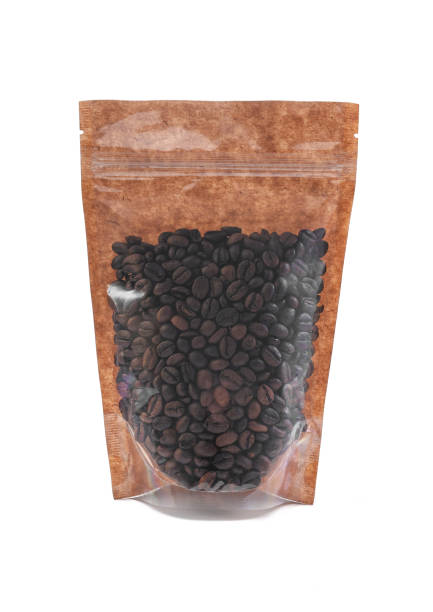 istock Coffee beans in a brown paper bag. Doy-pack with a plastic window for bulk products. Close-up. White background. Isolated. 1310393243