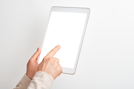 Women using digital tablet on white background with clipping path. Digtal tablet screen is empty. Showing to camera.