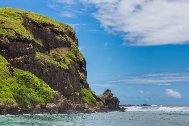 istock .Sheer green rock, Indian ocean and sky 1310394138