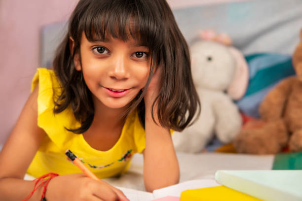 istock Happy girl doing homework at home. 1310394494
