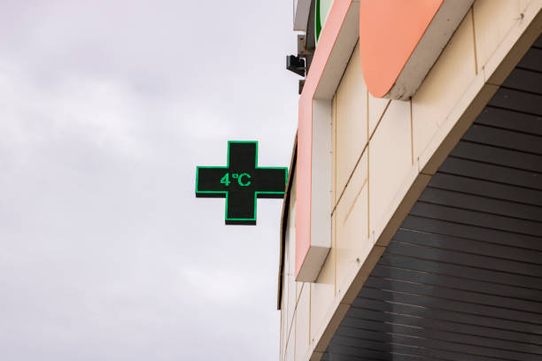 istock Green cross pharmacy sign on a building 1310395783