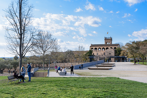 Sabadell - Catalonia, SPAIN - March 20th of 2021: wide view of the green area of the park of Can Gambus with the old Masia on the background