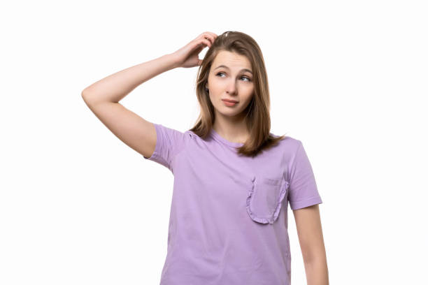 istock young pretty woman thinking and wonder. Studio shot, white background 1310398048