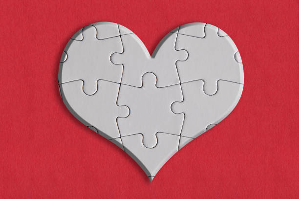istock Heart shape with puzzle pieces, on the red paper background 1310398151