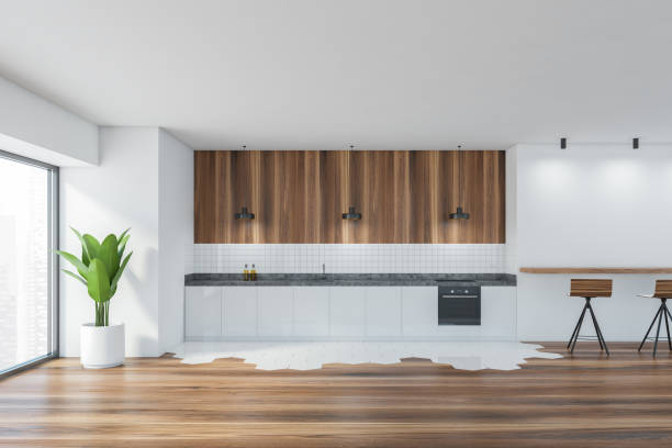 istock Modern kitchen interior with copy space on white wall, wooden countertops with a built in sink and a cooker. mock up. 1310398380