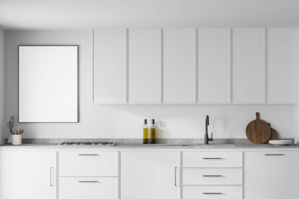 istock Modern kitchen interior with white walls, modern countertops with a built in sink and a cooker. Poster on white wall. 3d rendering mock up 1310399644