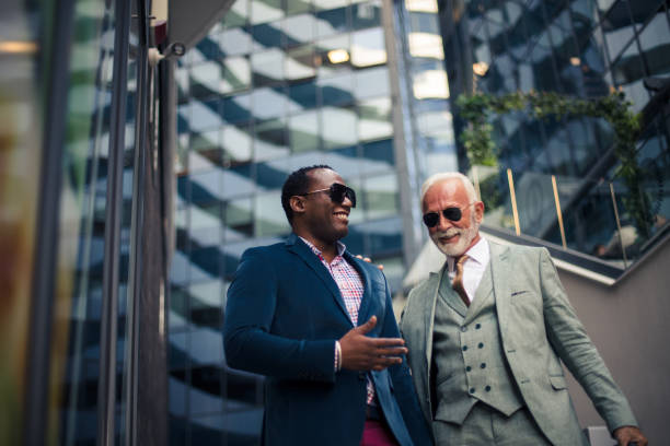 istock Businessmen discussing about work in outdoors. 1310399702