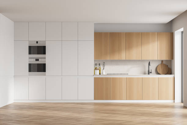 istock Modern kitchen interior with white walls, modern countertops with a built in sink and a cooker. 1310400092