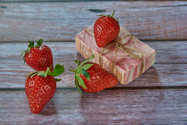 istock Pink textured handmade soap and delicious strawberries . 1310400721