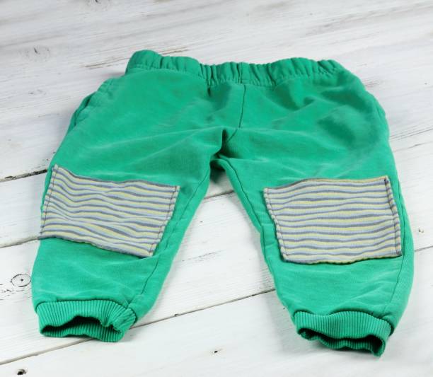 istock Children sweatpants mended with patches 1310402076