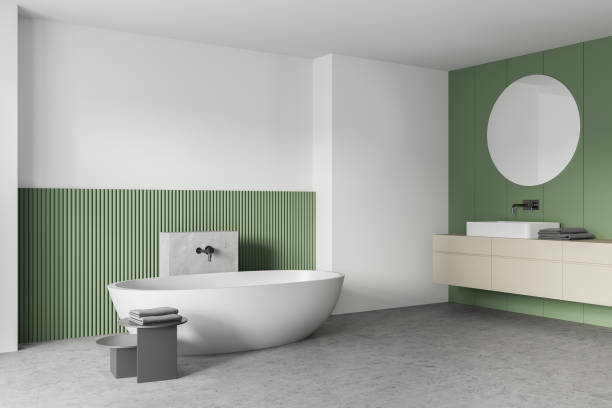 istock White and green bathroom with white bathtub, mirrors and marble floor 1310402313