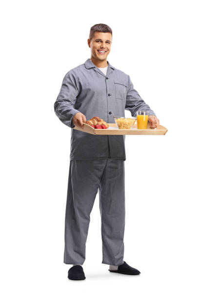 porträt eines lächelnden jungen mannes in pyjamas in voller länge - strawberry fruit single object food stock-fotos und bilder