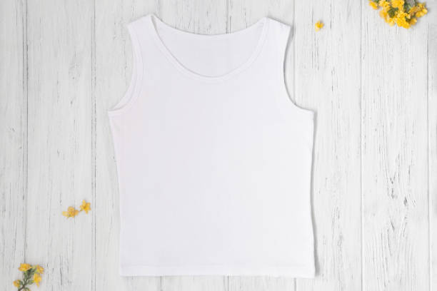 istock White tank top mockup with spring or summer yellow flowers, flat lay, top view 1310405628