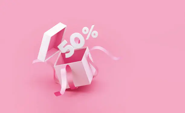 Photo of Sale Concept - Fifty Percent Discount Coming Out Of A White Gift Box Tied with Pink Ribbon