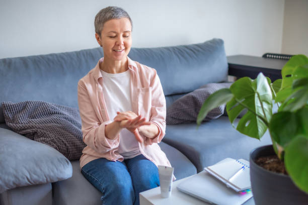 istock Woman using hand cream at home 1310407889