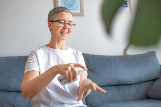 istock Woman using hand cream at home 1310407939