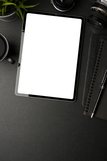 istock Creative flat lay workspace with digital tablet, supplies and copy space on black table 1310409399
