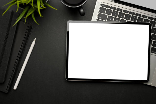 istock Creative flat lay workspace  with digital tablet, laptop and stationery on black table 1310409410