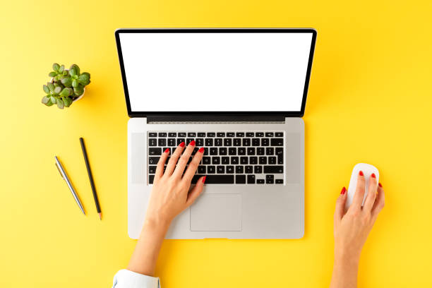 istock Businesswoman using laptop with empty screen. Business background with accessories. Top view 1310410458