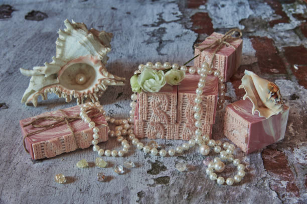 istock Pink handmade soap and pearl beads on a gray background. 1310411806