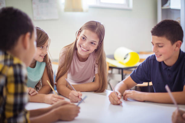 istock Great school work.  Teenagers students sitting in the classroom and talking. 1310412144