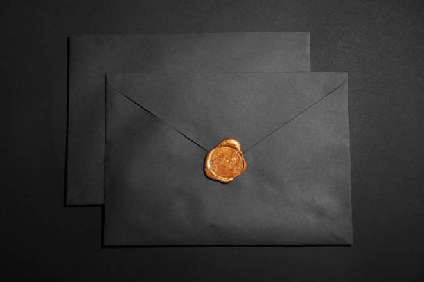 istock Envelopes with wax seal on black background, top view 1310413586