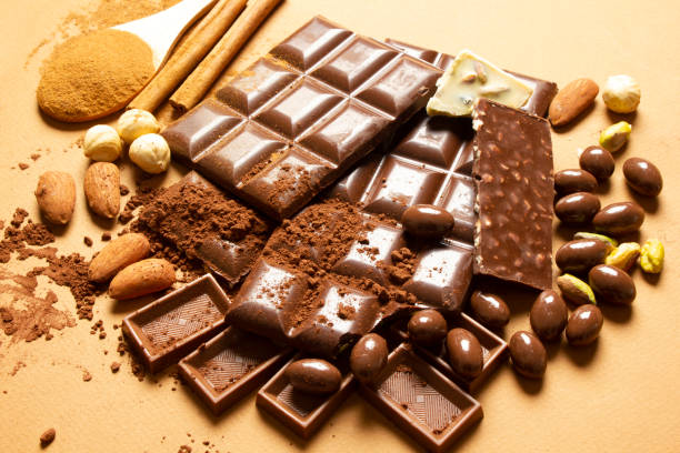 istock milk chocolates. Almond, pistachio, hazelnut.. background, texture.. 1310413904