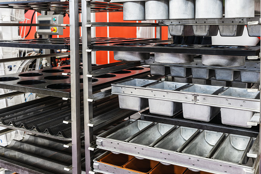 empty metal molds, trays and racks for baking bread and bakery products in a bakery or pastry shop