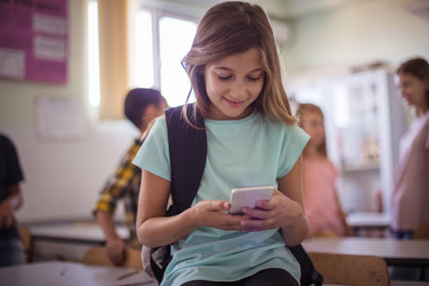 istock School girl typing on her smart phone. 1310414177