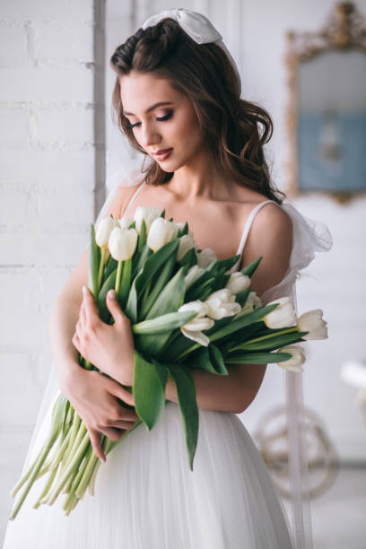istock Portrait of a beautiful bride with a bouquet in studio 1310415624