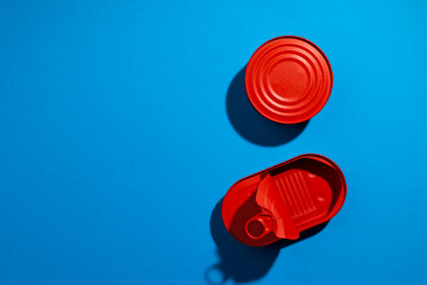 istock Red tin can on blue background close up 1310416508