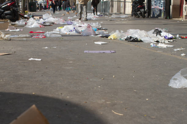 istock anonymous people walking through plastics and junk in the city 1310418562