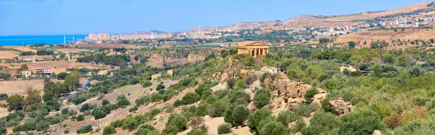 Aerial bird view of Kolymbethra Gardens and Valley of Temples, Agrigento, Sicily, Italy, with Temple of Concordia in the middle. Panoramic banner image. Summer sunny day, blue sky.