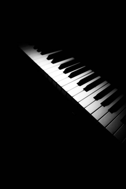 black and white piano, piano keys on a dark background