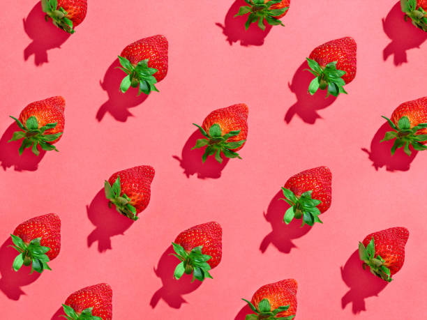 istock Strawberry pattern on pink background, from above, hard shadow 1310424269