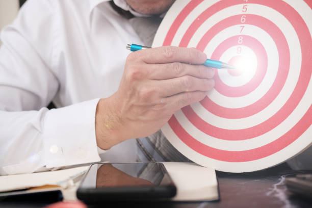 istock Businessman hand working on table and dart board with target and business growth concept, business plan successful 1310425030