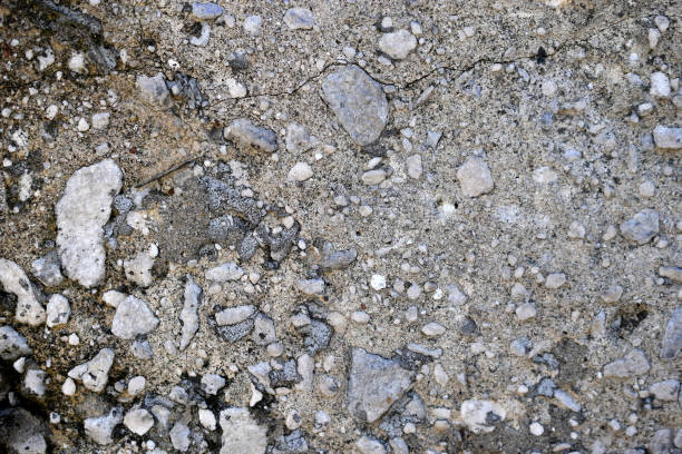 istock Stony gray concrete surface with pebbles and rubble 1310427807