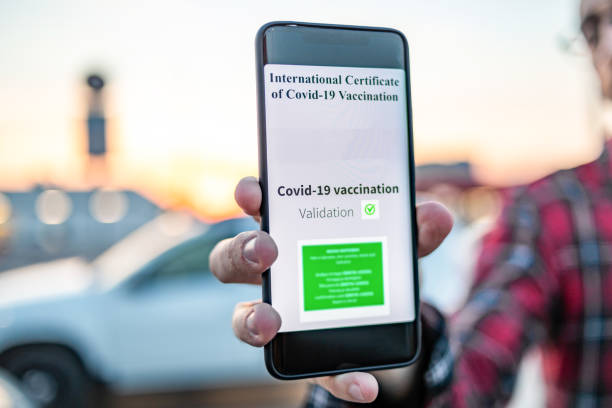 istock A man standing at the border crossing shows a valid vaccination certificate against COVID-19. A smartphone that displays a valid COVID-19 vaccination certificate with or without a QR code. 1310427861