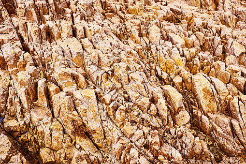 Rough textured rock formation on a rocky coastline.