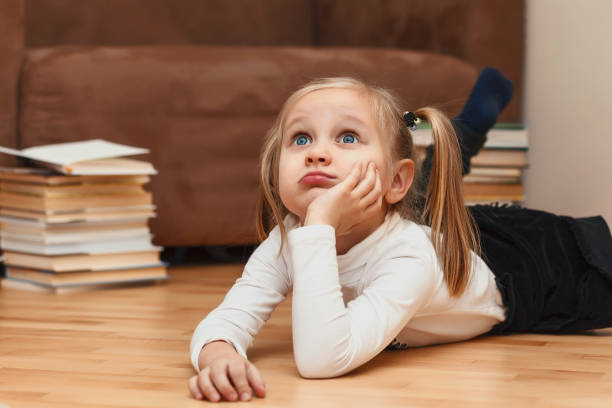 istock The child is bored lying on the floor. 1310428952