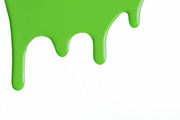 istock Green liquid drops of paint color flow down isolated white background. Abstract olive backdrop with fluid drip pattern. 1310430451