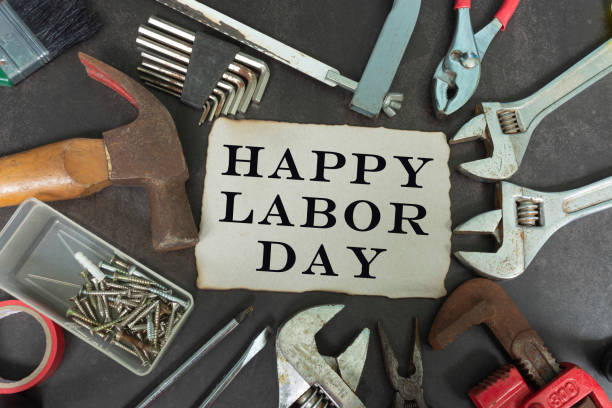 istock Happy labor day text on yellow notepad with repair equipment and many handy tools on a dark background 1310430793