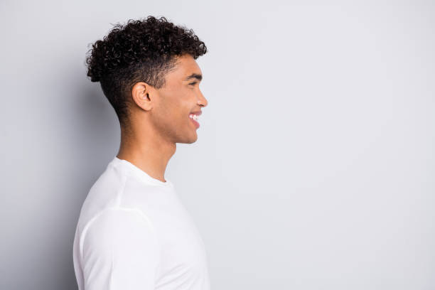 istock Profile portrait of brunet optimistic nice curly guy look empty space wear white t-shirt isolated on grey color background 1310431075