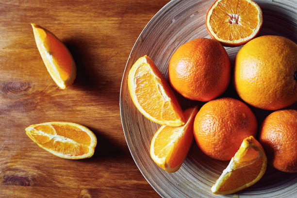 istock Slice of fresh oranges on wooden table 1310433113