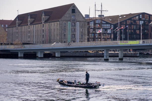 People in a small boat on a sunny spring day in the harbor of Copenhagen