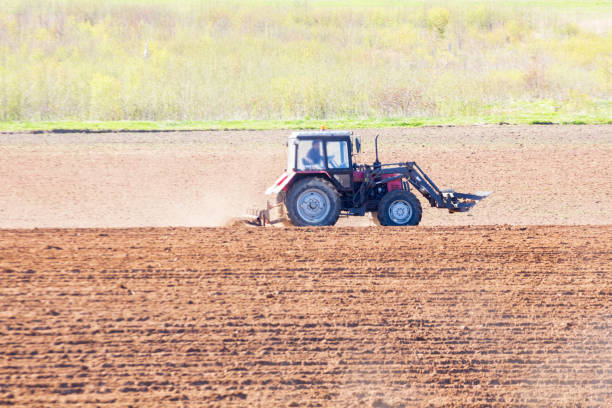 istock tractor plows the field on a sunny spring day 1310434226