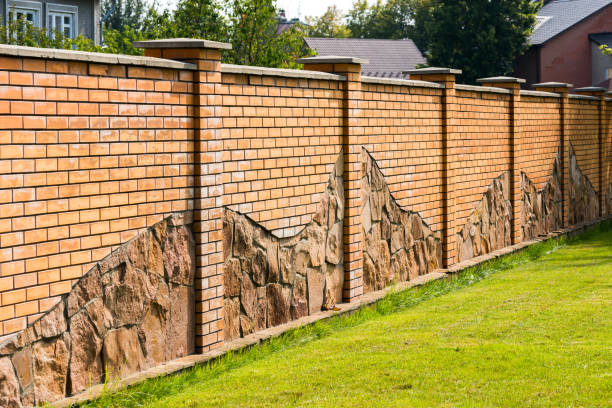 istock fence of stone and green lawn 1310435436