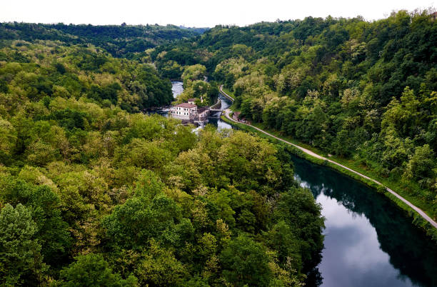 istock River Adda  through a forest and a small house in Lomardi 1310438694