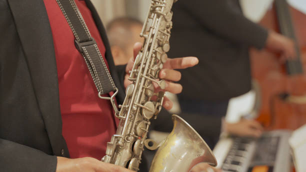 istock close up asian Saxophonist playing a saxophone on stage performance.. 1310439771